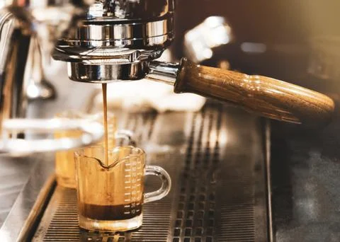 Espresso machine brewing a coffee. Coffee pouring into glasses in coffee sh.. Stock Photos