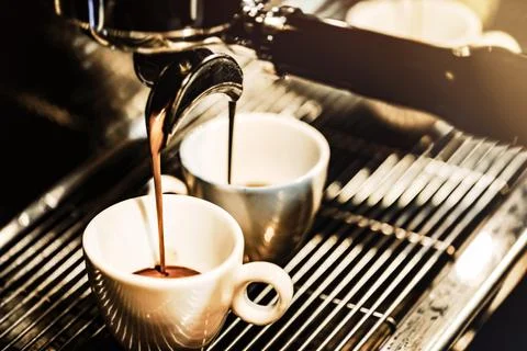Espresso machine brewing a coffee. Coffee pouring into glasses in coffee sh.. Stock Photos