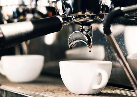 Espresso machine brewing a coffee. Coffee pouring into glasses in coffee sh.. Stock Photos