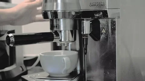 Espresso Machine Brewing Fresh Cafe Latte into White Ceramic Cup Stock Footage 337153082