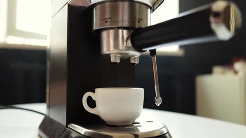 Espresso machine brewing a fresh cup of coffee in a white ceramic mug Video stock 339000186