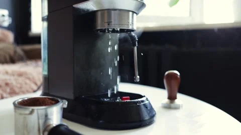 Espresso machine brewing hot coffee, water dripping into portafilter Stock Footage 338999890