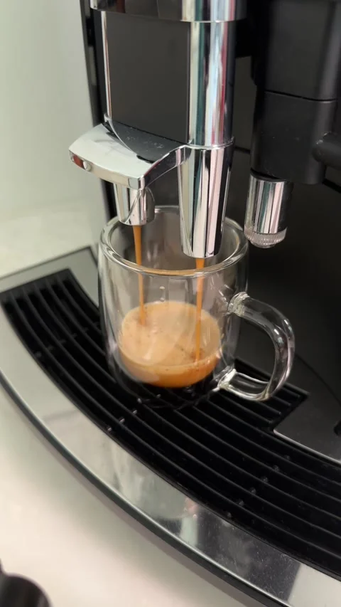 Espresso machine brewing process: closeup sequence capturing fresh coffee Stock Footage 320851425
