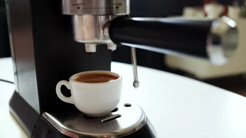 Espresso machine brewing a rich, aromatic coffee into a small white cup Stock Footage 339000667