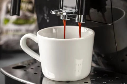 Espresso machine for making fresh coffee on a dark background close-up. Stock Photos