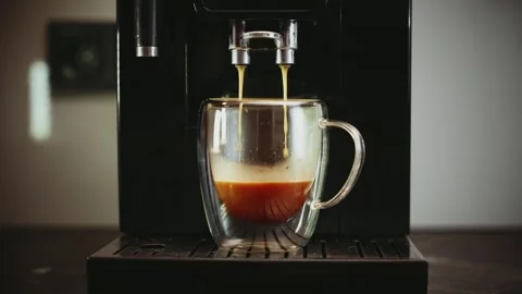 Espresso machine pouring fresh black coffee close-up glass cup transparent mug Stock Footage 334656858