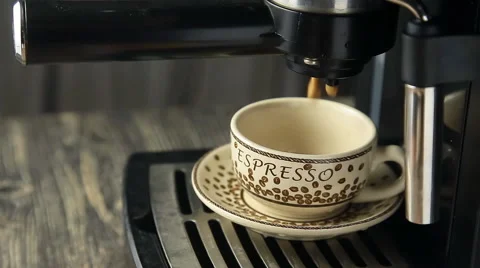 Espresso machine pouring strong looking fresh coffee into a neat  cup Stock Footage 58476709