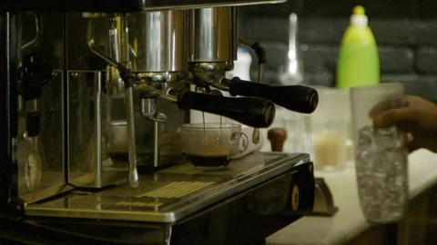 Espresso machine pours coffee into clear glass mug in a coffee shop 01 Stock Footage 122585486