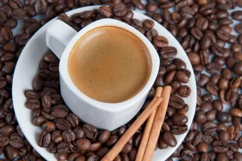 Espresso over cofe beans. Stock Photos