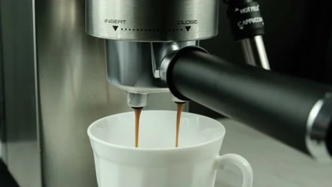 Espresso is poured into a cup from a coffee maker Stock Footage 153431836