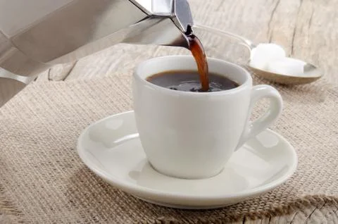 Espresso is poured into a cup Stock Photos