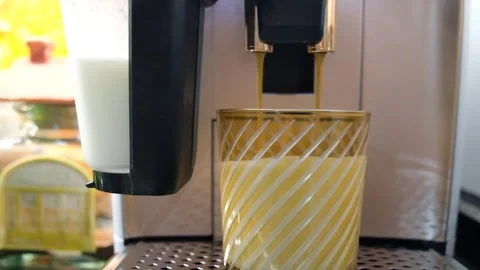 .Espresso Pouring into Frothy Milk to Create a Perfect Latte in a Stylish Cup Video stock 274894528