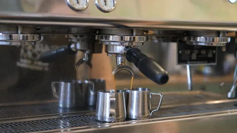 Espresso pouring from professional coffee machine Stock Footage 204727544