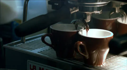 Espresso pouring while barista steams milk. Stock Footage 22666142
