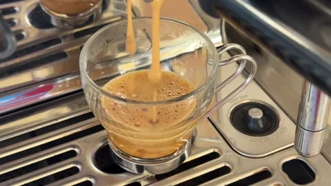 Espresso shot being pulled on a coffee machine Stock Footage 327383836