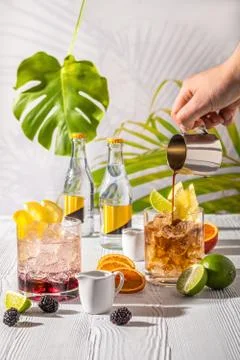 Espresso-tonic refreshing drink with different fruits and syrups on wooden ta Stock Photos