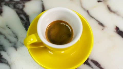 Espresso in Yellow Cup on Marble Countertop, Overhead Close Up Coffee Scene Stock Footage 337652842
