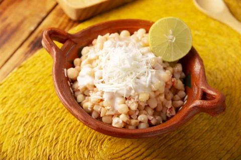 Esquites. Corn kernels cooked and served with mayo, sour cream, lemon and chi Stock Photos