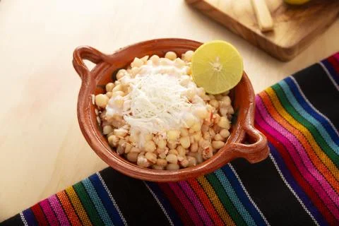 Esquites. Corn kernels cooked and served with mayo, sour cream, lemon and chi Stock Photos