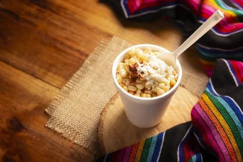 Esquites. Corn kernels cooked and served with mayo, sour cream, lemon and chi Stock Photos