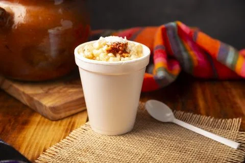 Esquites. Corn kernels cooked and served with mayo, sour cream, lemon and chi Stock Photos
