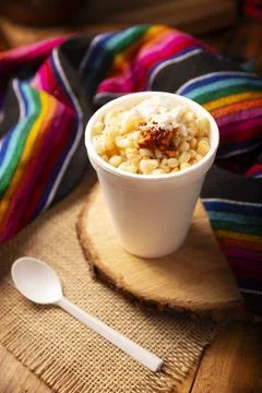 Esquites. Corn kernels cooked and served with mayo, sour cream, lemon and chi Stock Photos
