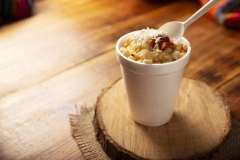 Esquites. Corn kernels cooked and served with mayo, sour cream, lemon and chi Stock Photos