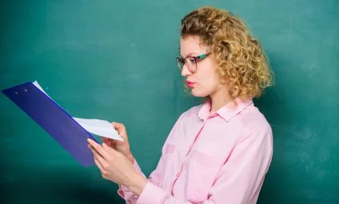 Essay writing. teacher with document folder. student in glasses at blackboard Stock Photos