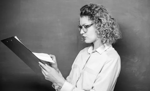 Essay writing. teacher with document folder. student in glasses at blackboard Stock Photos