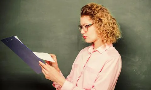 Essay writing. teacher with document folder. student in glasses at blackboard Stock Photos