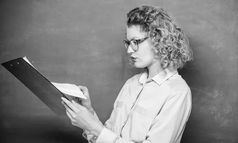 Essay writing. teacher with document folder. student in glasses at blackboard Stock Photos