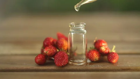 Essence of Wild strawberry on table in beautiful glass jar Vidéo 112584072