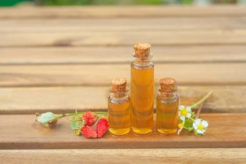 Essence of Wild strawberry on table in beautiful glass jar Stock Photos