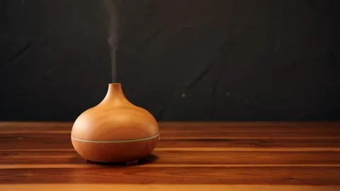 Essential aroma oil diffuser on the wooden table Stock Footage 209540788