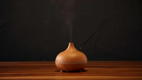 Essential aroma oil diffuser on the wooden table. Stock Footage 209540998