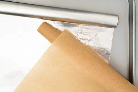 Essential baking supplies, including parchment paper, aluminum foil, and a .. Stock Photos