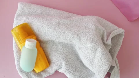 Essential beach accessories with sunscreen and skincare lotion for summer v.. Stock Footage 334552110