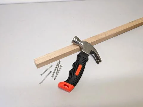 Essential Carpentry Tools: Hammer, Nails, and Wooden Plank on White Backgroun Stock Photos