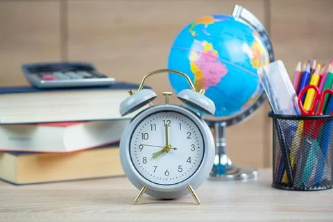 Essential items for a study desk include a clock, a globe, and a variety of.. Stock Photos