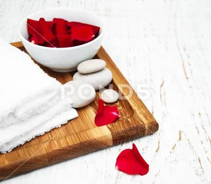 Essential oil and rose petals Stock Photos