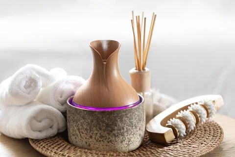 Essential oil aroma diffuser humidifier diffusing water articles in the air. Stock Photos