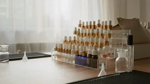 Essential Oil Bottles Standing on Rack for Perfume Master Class Stock Footage 337106532