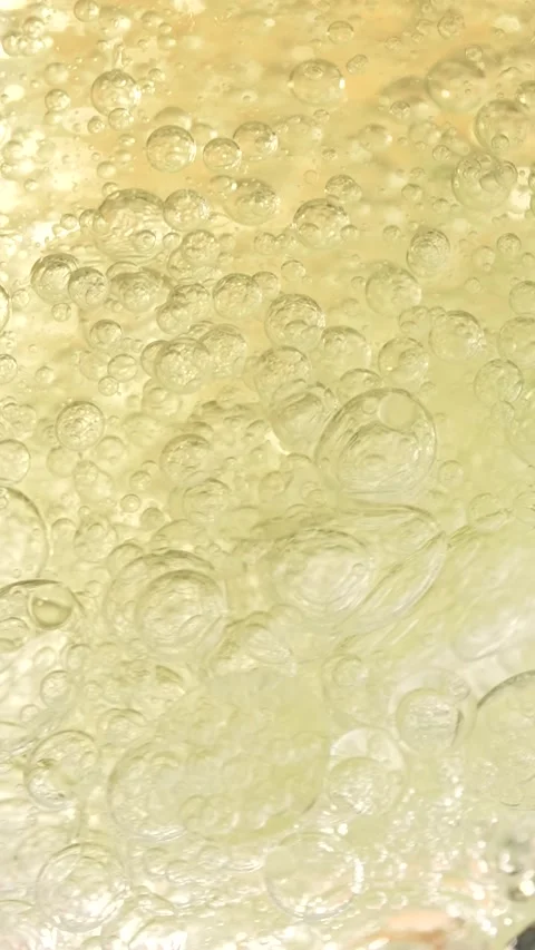 Essential oil bubbles, macro shot, cosmetics concept. Golden liquid bubbles.. Stock Footage 297863794