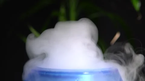 Essential oil diffuser and humidifier close up with mixed water steam. Dark d Stock Footage 169613324