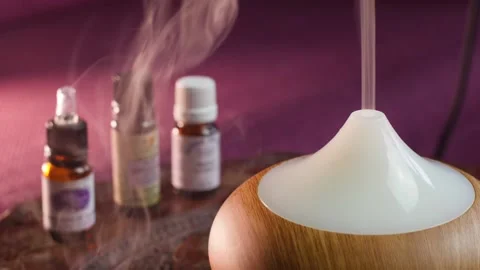 Essential oil diffuser, and three essential oil bottles Stock Footage 144246955