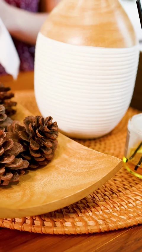 Essential Oil Diffuser with Reed Sticks and Pine Cones on Wooden Tray 스톡 동영상 333306354