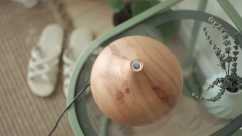 Essential oil diffuser on a table with shoes nearby Stock Footage 329339266