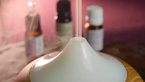 Essential oil diffuser working, close up of smoke and smooth background Stock Footage 144246963