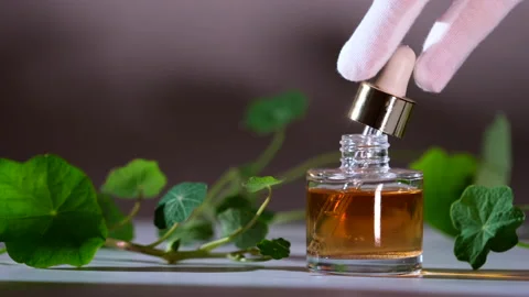 Essential Oil Product. Drops falling from cosmetic pipette to perfume bottle Stock Footage 144339045