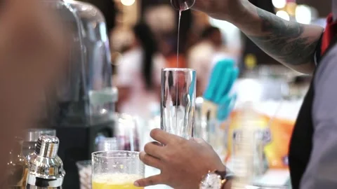 Established Shot of a Man Preparing Orange Cocktail Stock Footage 132022903